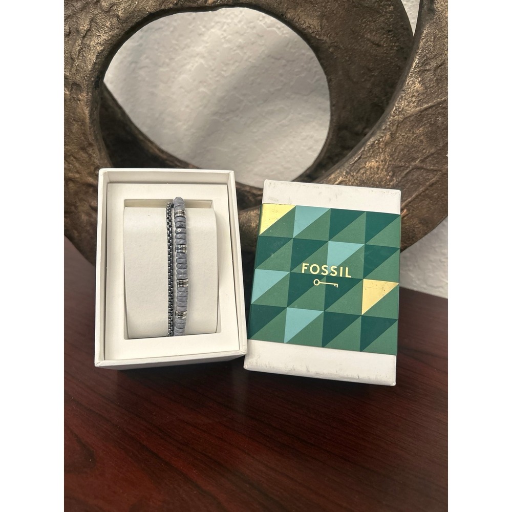 Fossil bracelet features a layered design with gray beaded and silver chains NWT